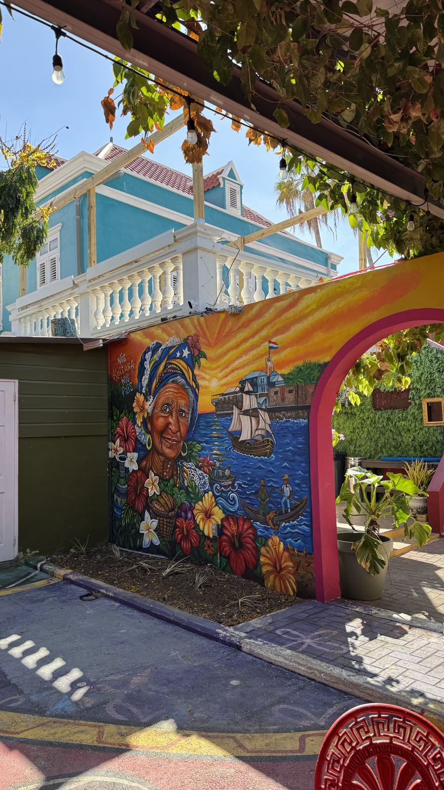 Mural and colourful Otrobanda buildings seen from the yard